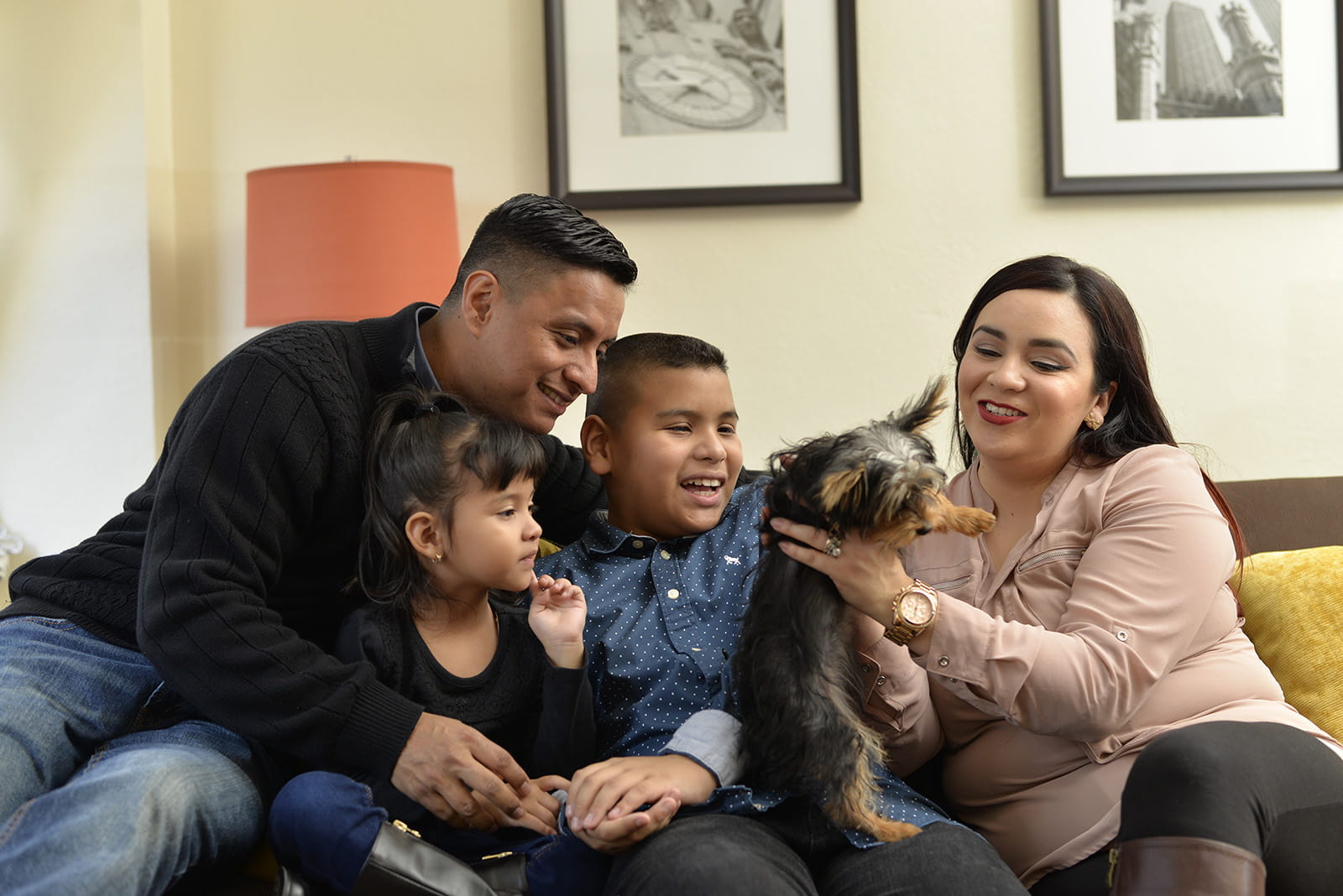 Family in hotel room with dog
