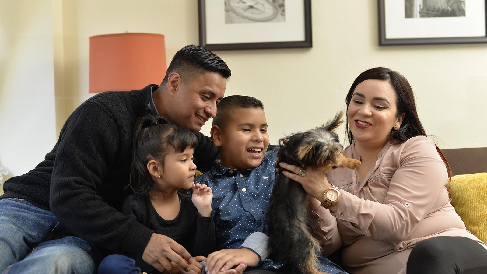 Family in hotel room with dog