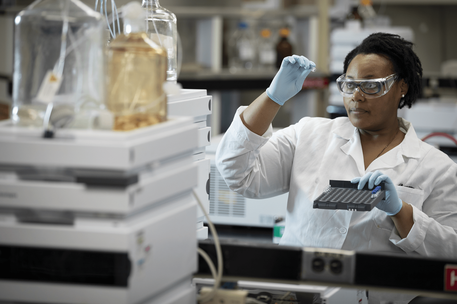 Woman_Looking_At_Vial2_Horiz 1600x